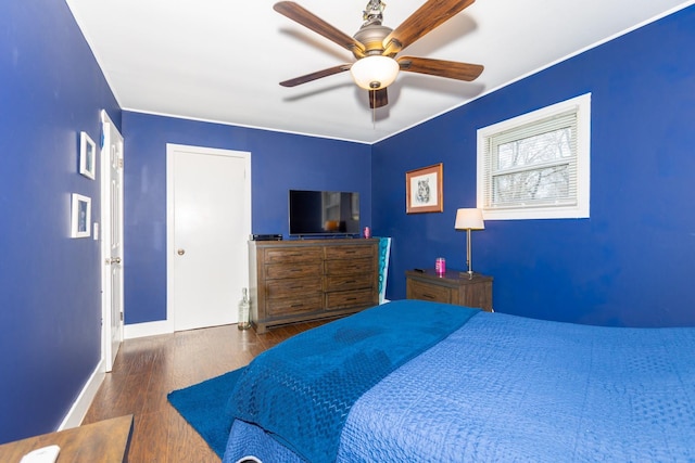 bedroom with baseboards, wood finished floors, and ceiling fan