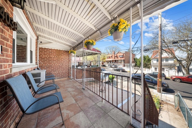 balcony with central AC unit and covered porch