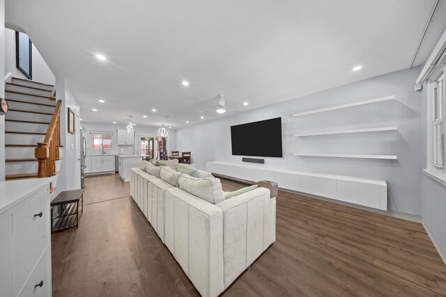 living room with ceiling fan, wood finished floors, recessed lighting, and stairway