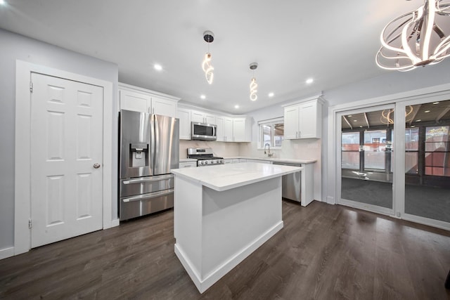 kitchen with dark wood finished floors, appliances with stainless steel finishes, white cabinetry, and recessed lighting
