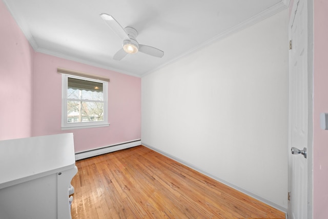 empty room with crown molding, a baseboard heating unit, ceiling fan, light wood finished floors, and baseboards