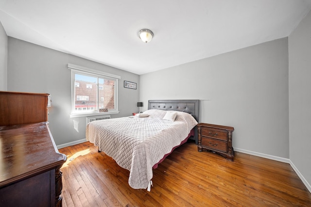 bedroom featuring hardwood / wood-style floors and baseboards