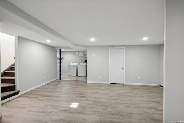 finished below grade area with recessed lighting, stairs, baseboards, washer and dryer, and wood finished floors