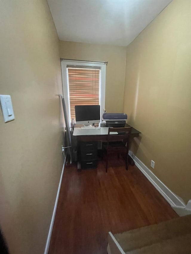office space featuring dark wood-style flooring and baseboards