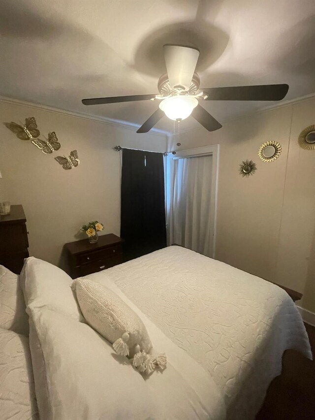 bedroom featuring ceiling fan and ornamental molding