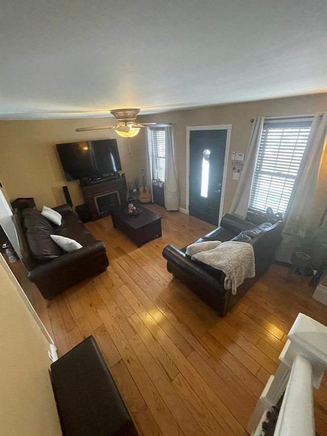 living area featuring a ceiling fan and hardwood / wood-style floors