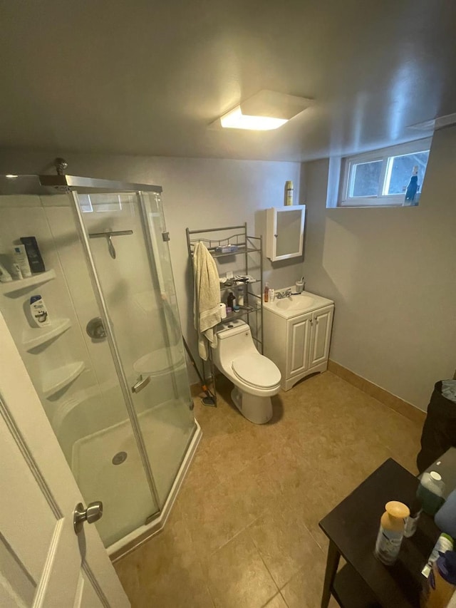 bathroom featuring toilet, a stall shower, and vanity