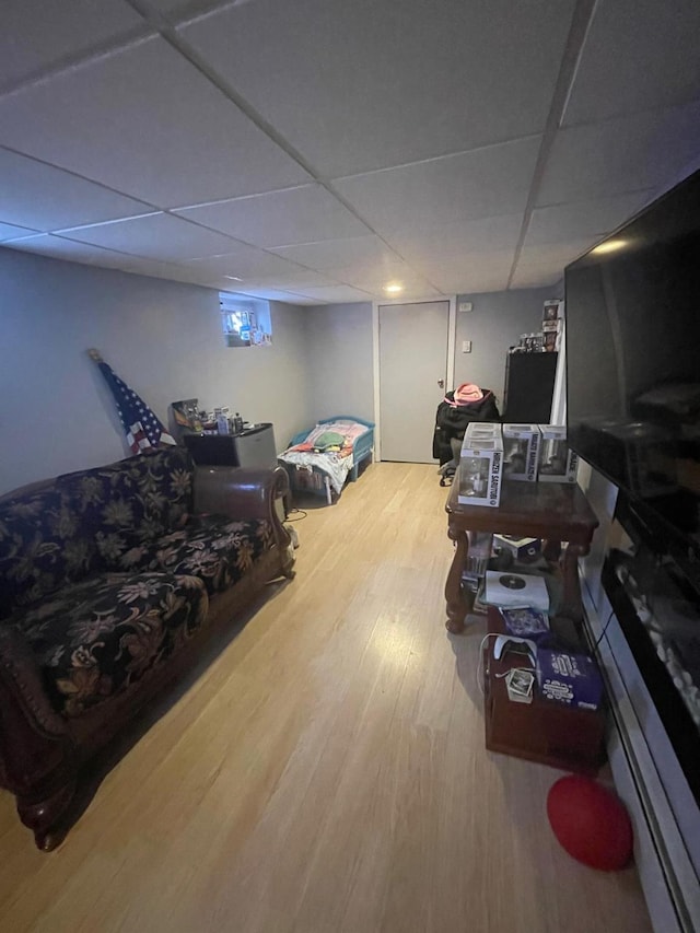 interior space featuring a drop ceiling and wood finished floors