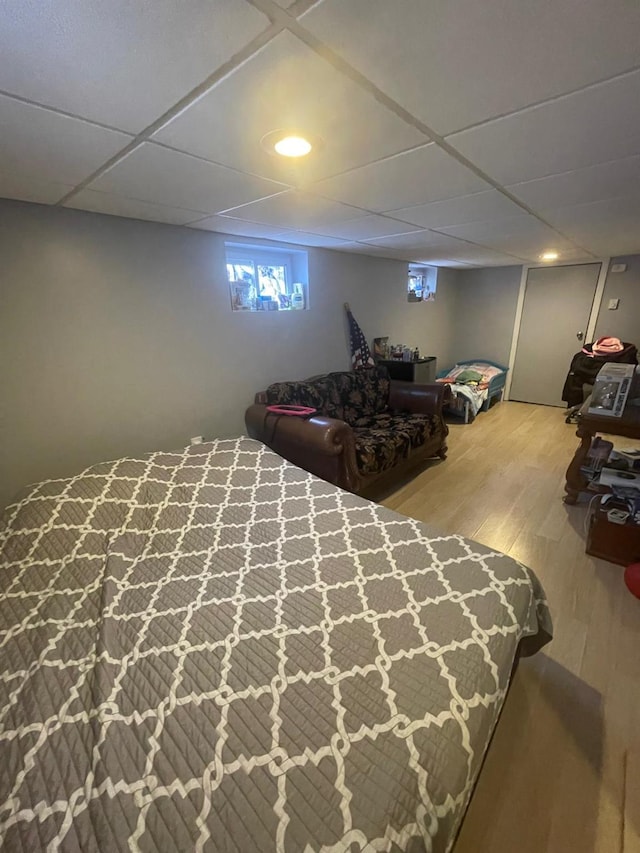 bedroom with recessed lighting, a paneled ceiling, and wood finished floors