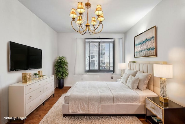 bedroom featuring an inviting chandelier and baseboards