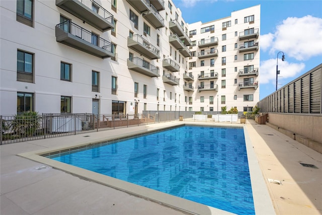 community pool featuring fence