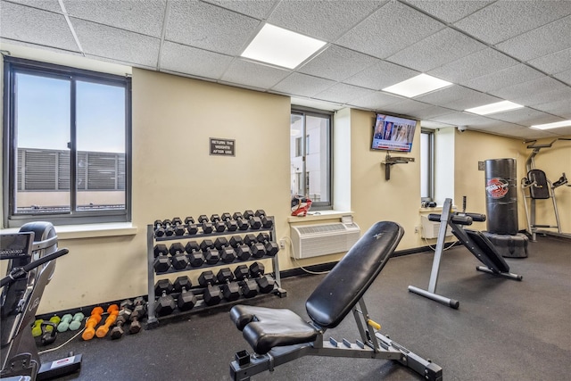 gym with a paneled ceiling