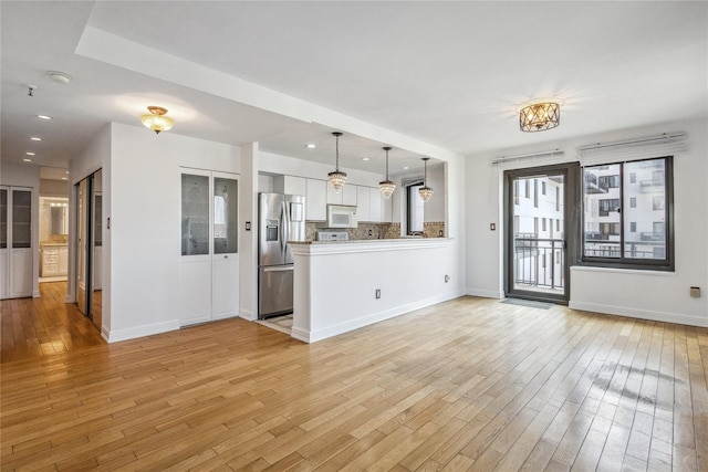 100 W Broadway Unit 4C, Long Beach, NY 11561 - unfurnished living room with light wood-style flooring, baseboards, and recessed lighting