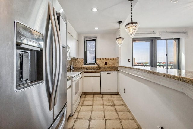 100 W Broadway Unit 4C, Long Beach, NY 11561 - kitchen featuring white appliances, a sink, stone tile floors, white cabinetry, and recessed lighting