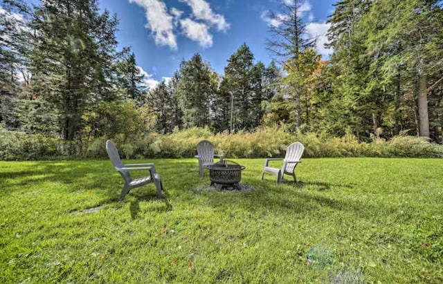 view of yard with an outdoor fire pit