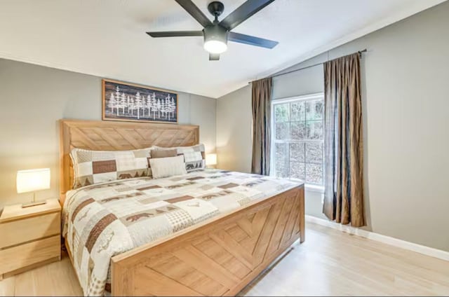 bedroom with ceiling fan, light wood finished floors, and baseboards