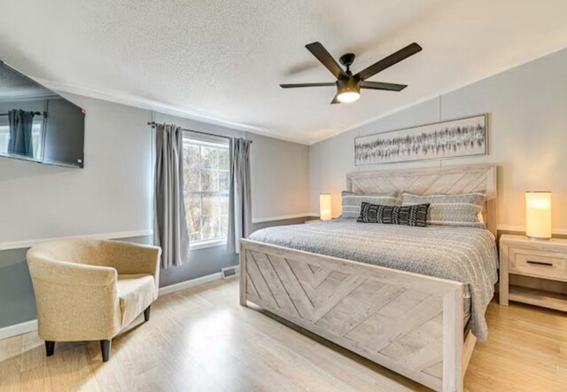 bedroom with wood finished floors, baseboards, and a ceiling fan