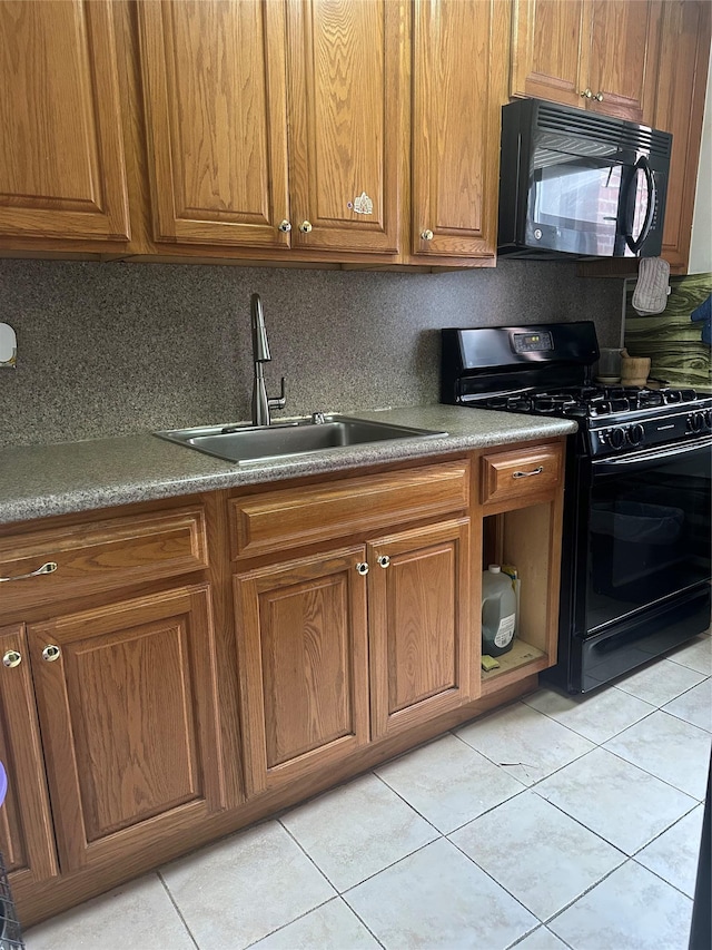 87-30 204th St Unit A78, Hollis, NY 11423 - kitchen with black appliances, a sink, brown cabinetry, and light tile patterned floors