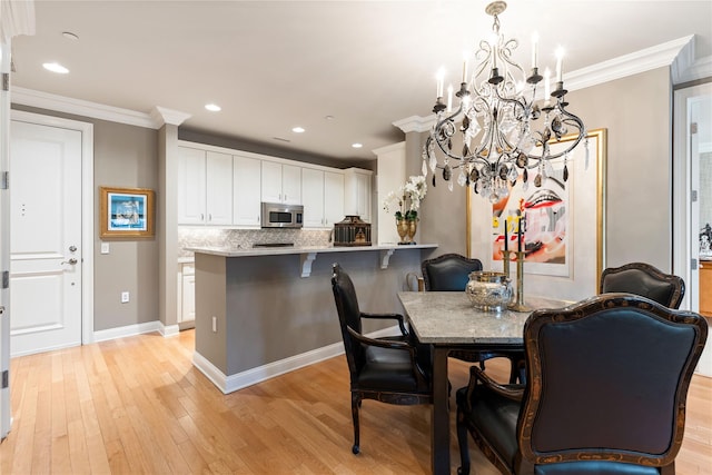1 Christie Pl Unit 205W, Scarsdale, NY 10583 - dining area featuring ornamental molding, recessed lighting, a notable chandelier, and light wood-type flooring
