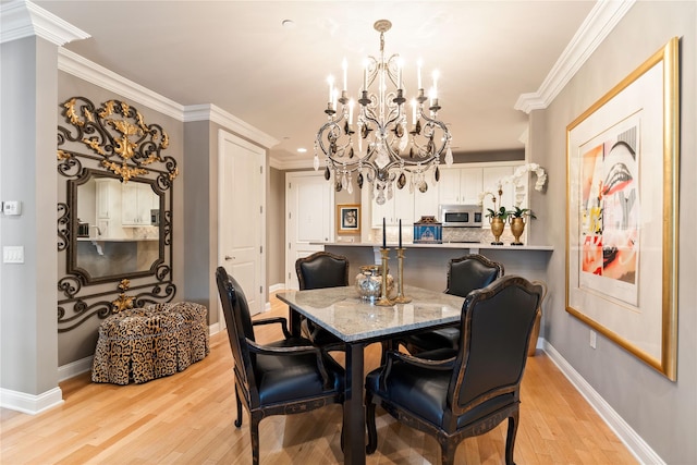 1 Christie Pl Unit 205W, Scarsdale, NY 10583 - dining room with baseboards, ornamental molding, a notable chandelier, and light wood finished floors
