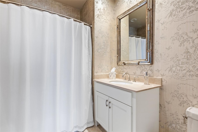 1 Christie Pl Unit 205W, Scarsdale, NY 10583 - bathroom featuring wallpapered walls, toilet, and vanity