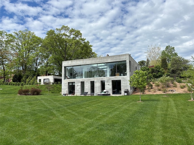 back of property featuring a lawn