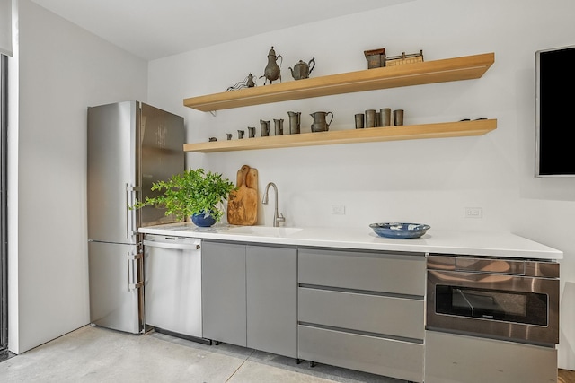 112 Wilson Park Dr, Tarrytown, NY 10591 - kitchen featuring a sink, appliances with stainless steel finishes, gray cabinets, open shelves, and light countertops