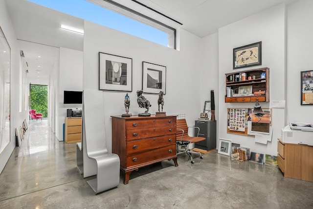 112 Wilson Park Dr, Tarrytown, NY 10591 - sitting room with concrete flooring, a desk, and radiator heating unit