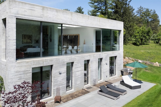 112 Wilson Park Dr, Tarrytown, NY 10591 - rear view of house featuring a patio area and a lawn
