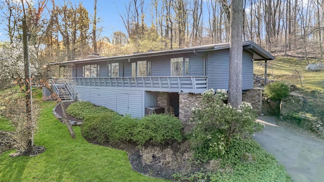view of home's exterior featuring a yard and stairs