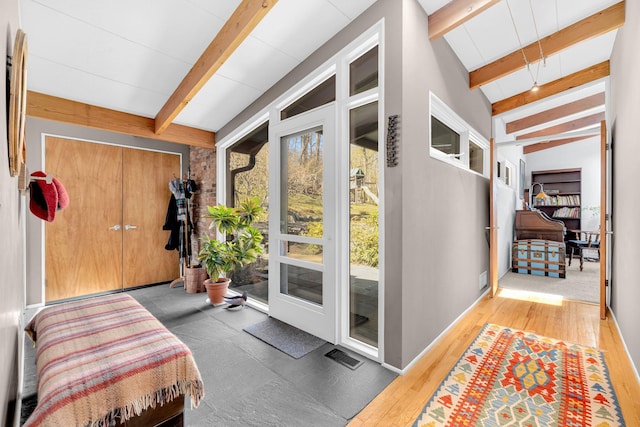 doorway to outside featuring beam ceiling and visible vents