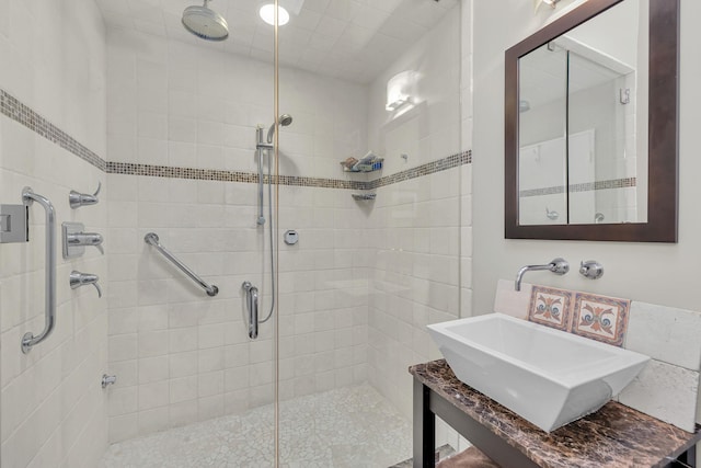 full bathroom featuring a shower stall and a sink