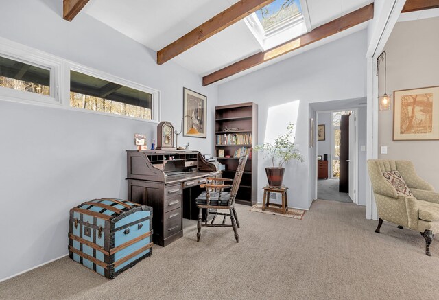 home office with beamed ceiling, carpet floors, and a skylight