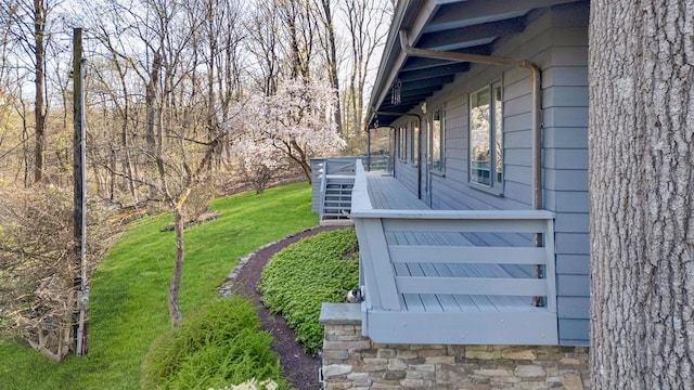 view of property exterior featuring stairway, a yard, and a wooden deck