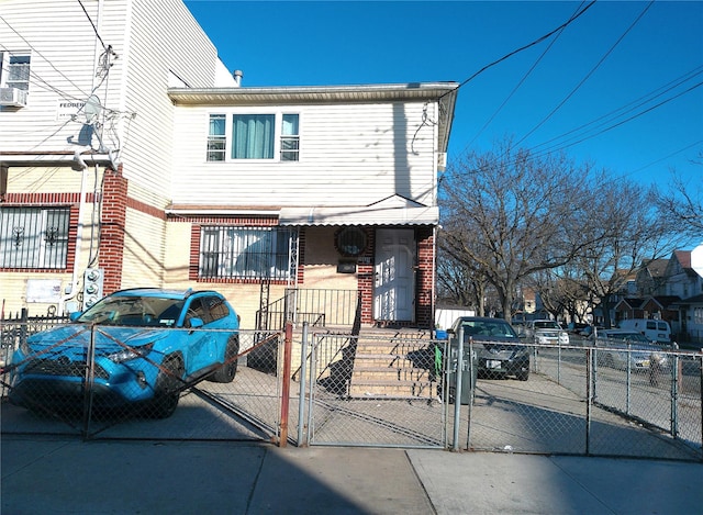 view of front facade with a gate, brick siding, and a fenced front yard