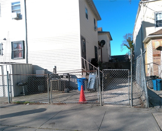 view of side of home with a gate and fence private yard