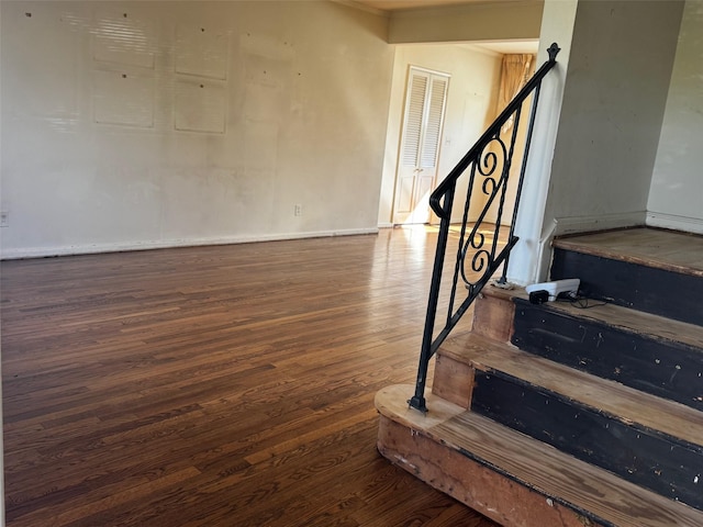 stairway featuring baseboards and wood finished floors
