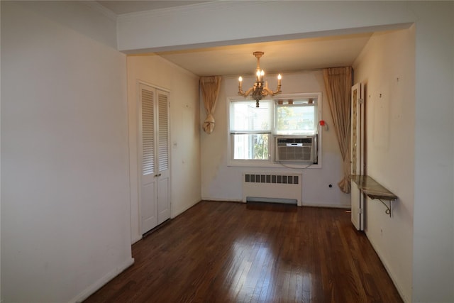 unfurnished dining area featuring a chandelier, radiator heating unit, baseboards, and hardwood / wood-style flooring