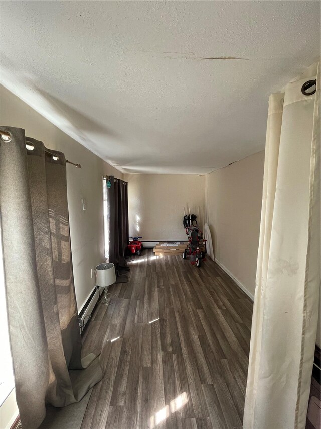 340 Rte 52, Carmel, NY 10512 - interior space with a textured ceiling, a baseboard radiator, a baseboard heating unit, baseboards, and wood finished floors