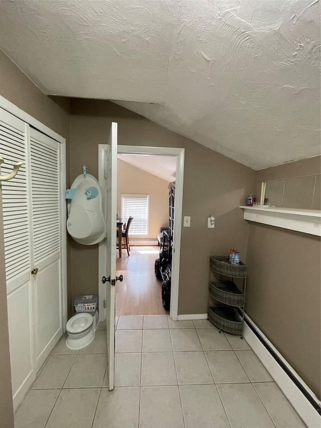 340 Rte 52, Carmel, NY 10512 - bathroom with a baseboard radiator, tile patterned floors, baseboards, a textured ceiling, and lofted ceiling