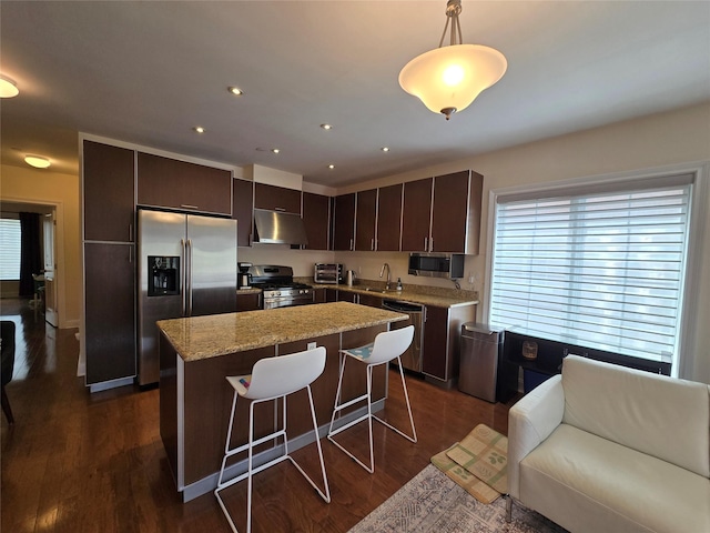 337 Park Cres, College Point, NY 11356 - kitchen with stainless steel appliances, under cabinet range hood, a sink, a kitchen island, and dark brown cabinetry