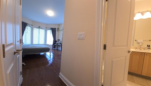 337 Park Cres, College Point, NY 11356 - bedroom featuring a sink, wood finished floors, and ensuite bathroom