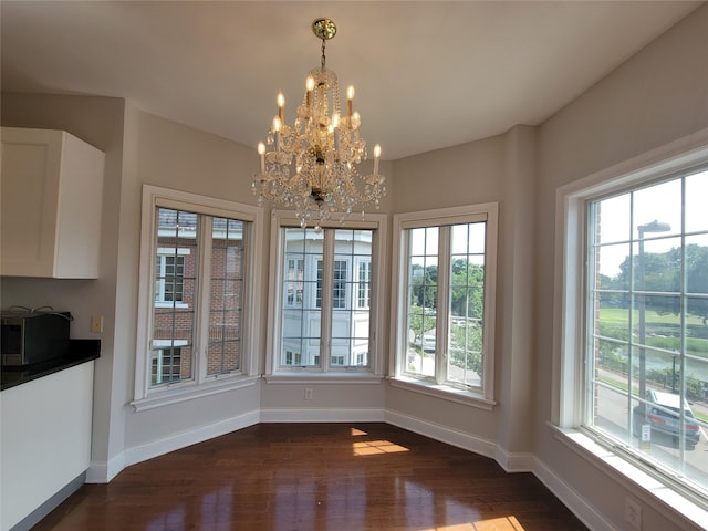 337 Park Cres, College Point, NY 11356 - unfurnished dining area featuring a chandelier, dark wood-style floors, and baseboards