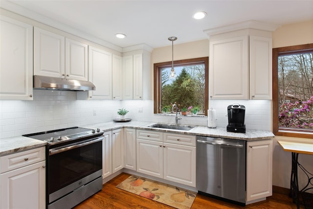 kitchen with under cabinet range hood, a sink, white cabinetry, and appliances with stainless steel finishes