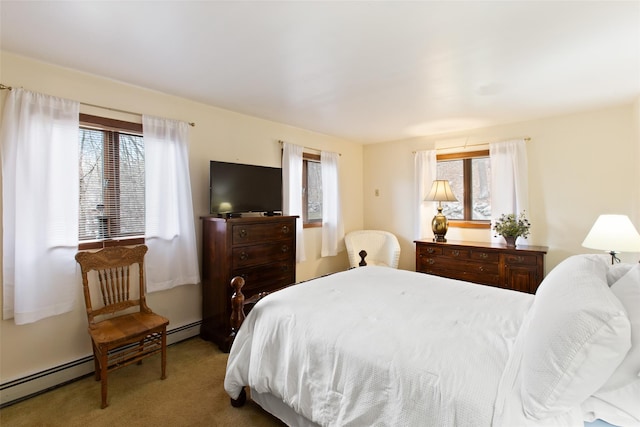 bedroom featuring baseboard heating, carpet floors, and multiple windows
