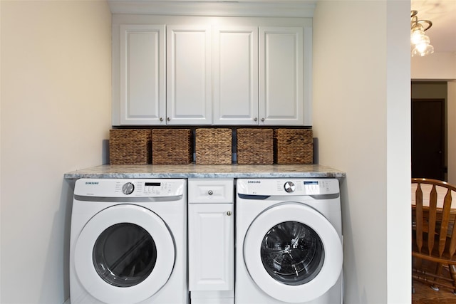 washroom featuring washer and dryer and cabinet space