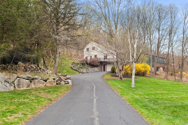 exterior space with a garage, driveway, and a front lawn