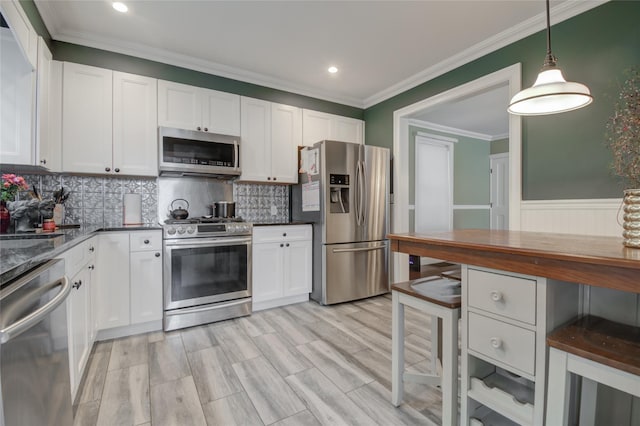163 N Hamilton St, Poughkeepsie, NY 12601 - kitchen with white cabinets, decorative backsplash, ornamental molding, and stainless steel appliances