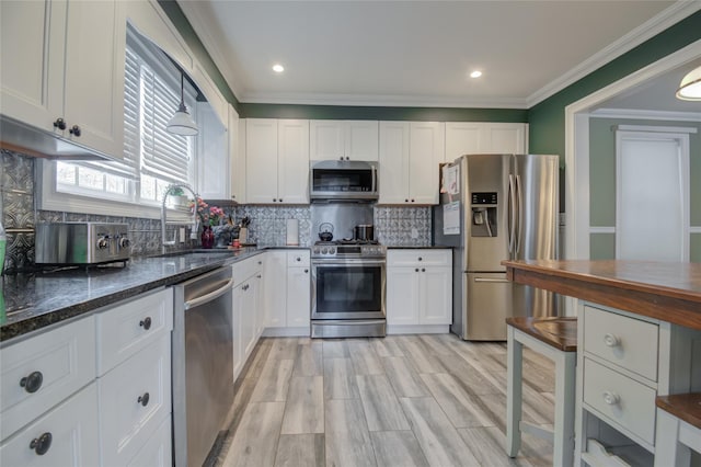 163 N Hamilton St, Poughkeepsie, NY 12601 - kitchen with ornamental molding, white cabinetry, and stainless steel appliances