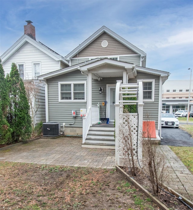 163 N Hamilton St, Poughkeepsie, NY 12601 - view of front facade with a chimney and cooling unit